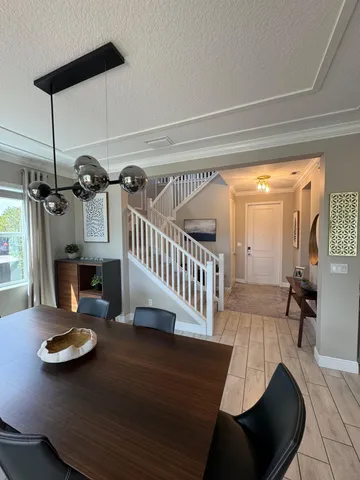 a view of a dining room with furniture wooden floor and chandelier