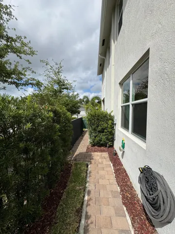 a view of a pathway both side of house