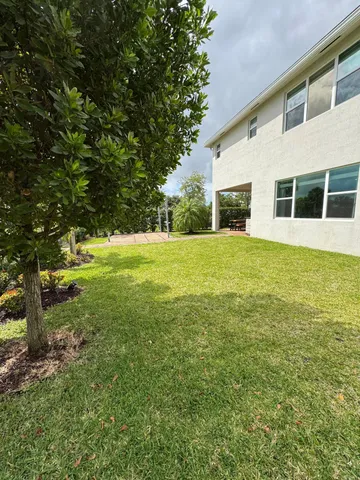 a view of a big yard with an outdoor space