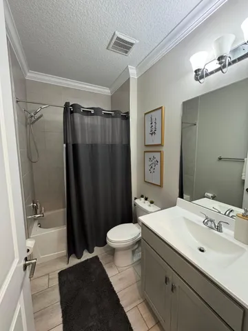 a bathroom with a sink a toilet a shower and a mirror