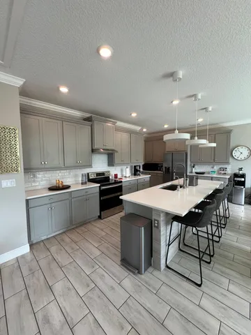 a kitchen with a sink a counter top space and appliances