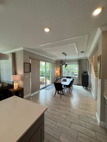 a view of a dining room with furniture and a large window