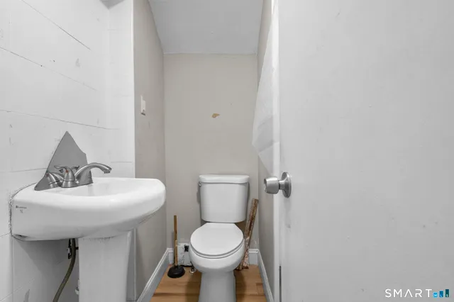 a bathroom with a sink toilet and a mirror