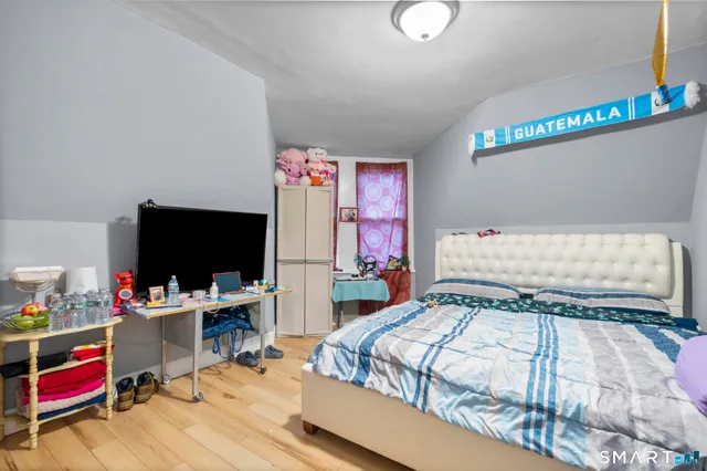 a bedroom with a bed and a flat screen tv