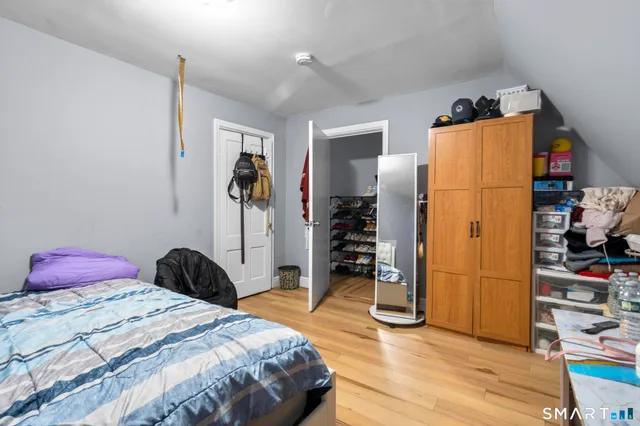 a bedroom with a bed and a walk in closet