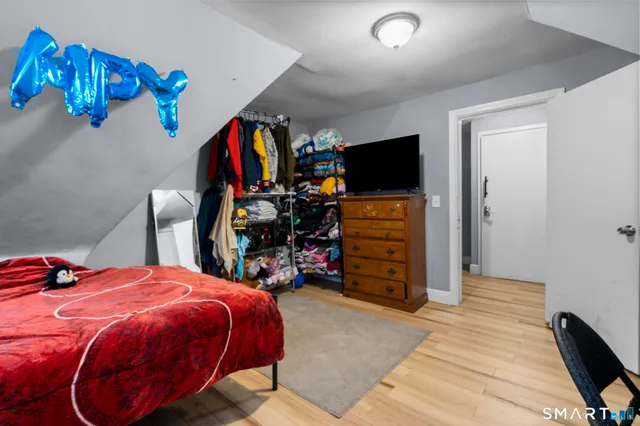 a bed room with a bed and a television