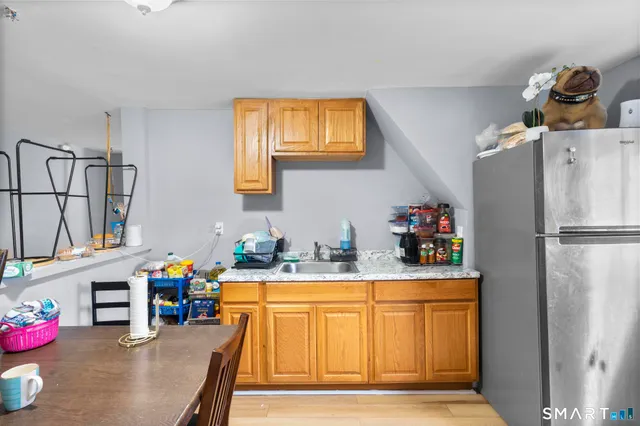 a kitchen with stainless steel appliances granite countertop a refrigerator and a sink