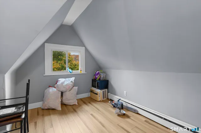 a room with wooden floor and furniture