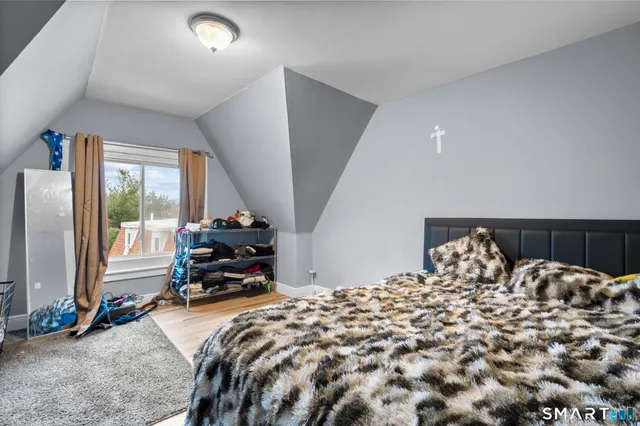 a bed sitting in a bedroom next to a window