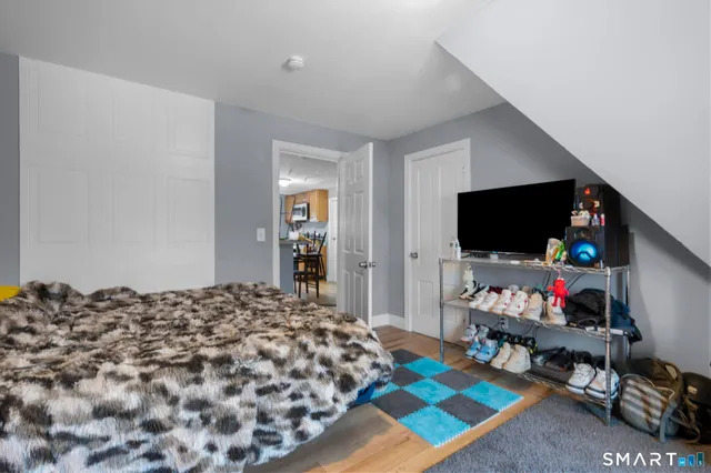 a bedroom with a bed and a flat screen tv