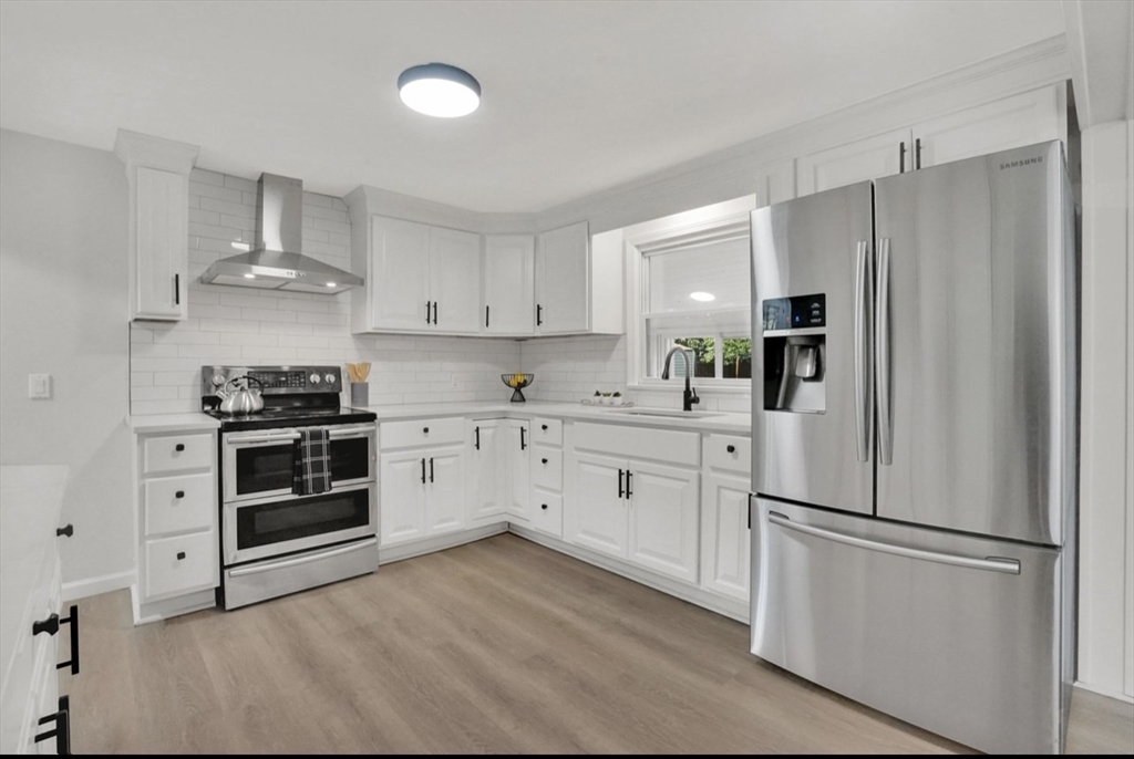 3 Benham Street Springfield, MA 01109 - Photo 8 of 29 a kitchen with cabinets stainless steel appliances and a counter space