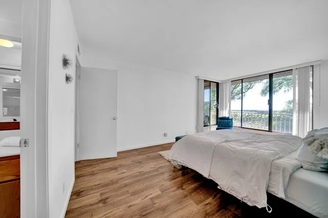 a bedroom with a bed and a large window