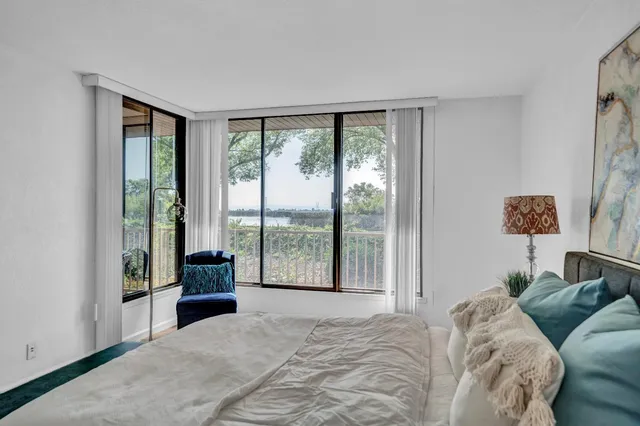 a bedroom with a bed and a large window