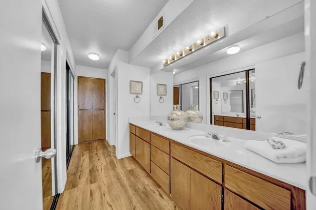 a bathroom with a sink double vanity granite tub and shower
