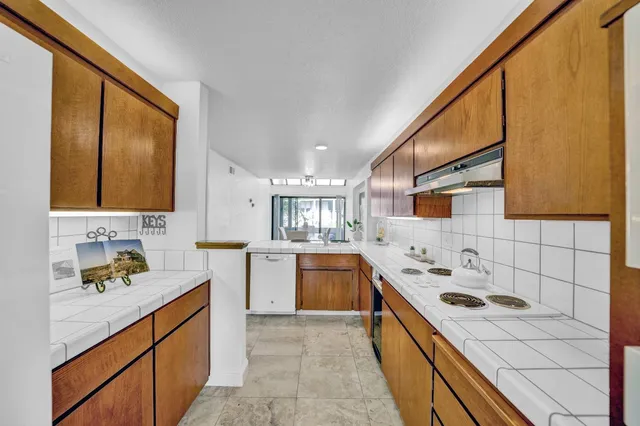 a view of a fountain in front of a house with a big yard