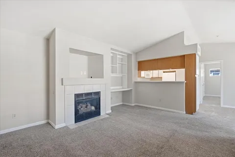 a view of empty room with a fireplace