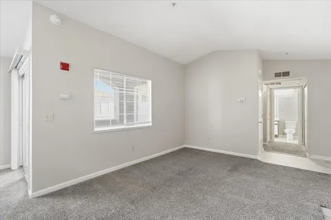an empty room with windows and closet