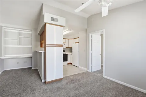 a view of a kitchen with a refrigerator and a sink