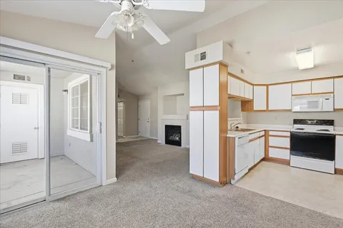 a kitchen with a refrigerator and a stove top oven