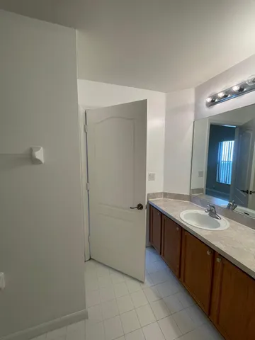 a bathroom with a sink vanity and a mirror