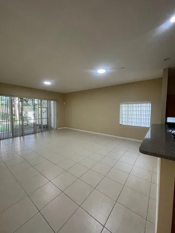 an empty room with closet and a window