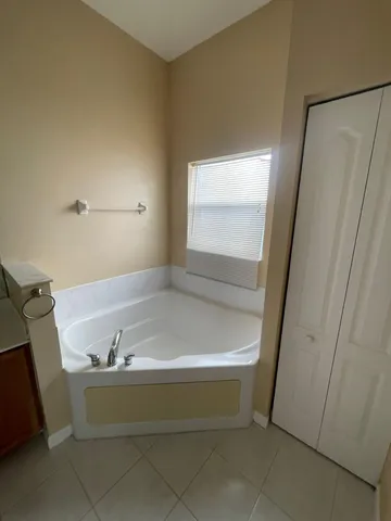 a spacious bathroom with a granite countertop sink and a mirror