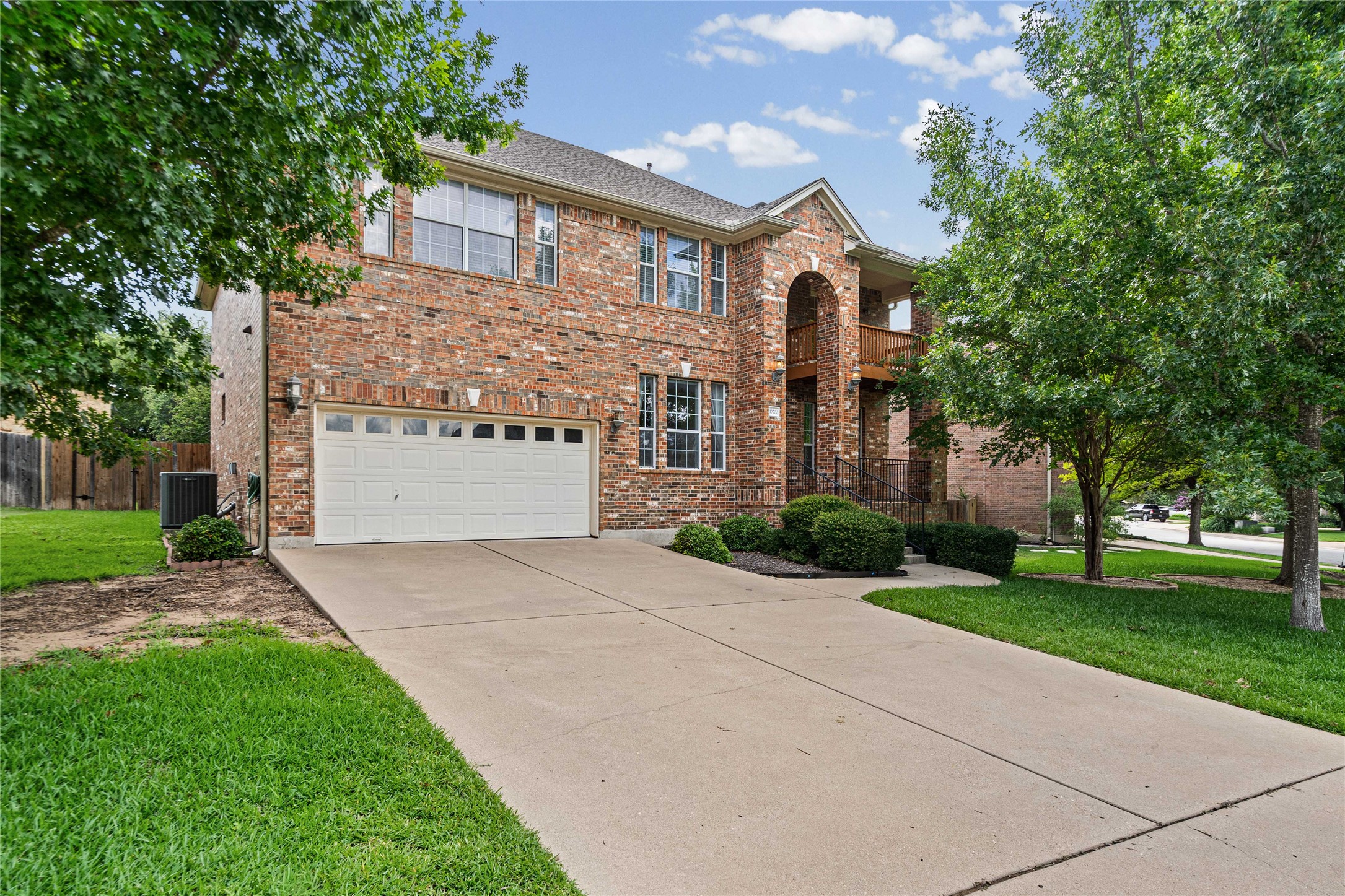 10700 Pointe View Drive Austin, TX 78738 - Photo 2 of 35 A classic brick exterior with a welcoming arched entry and a convenient two-car garage.