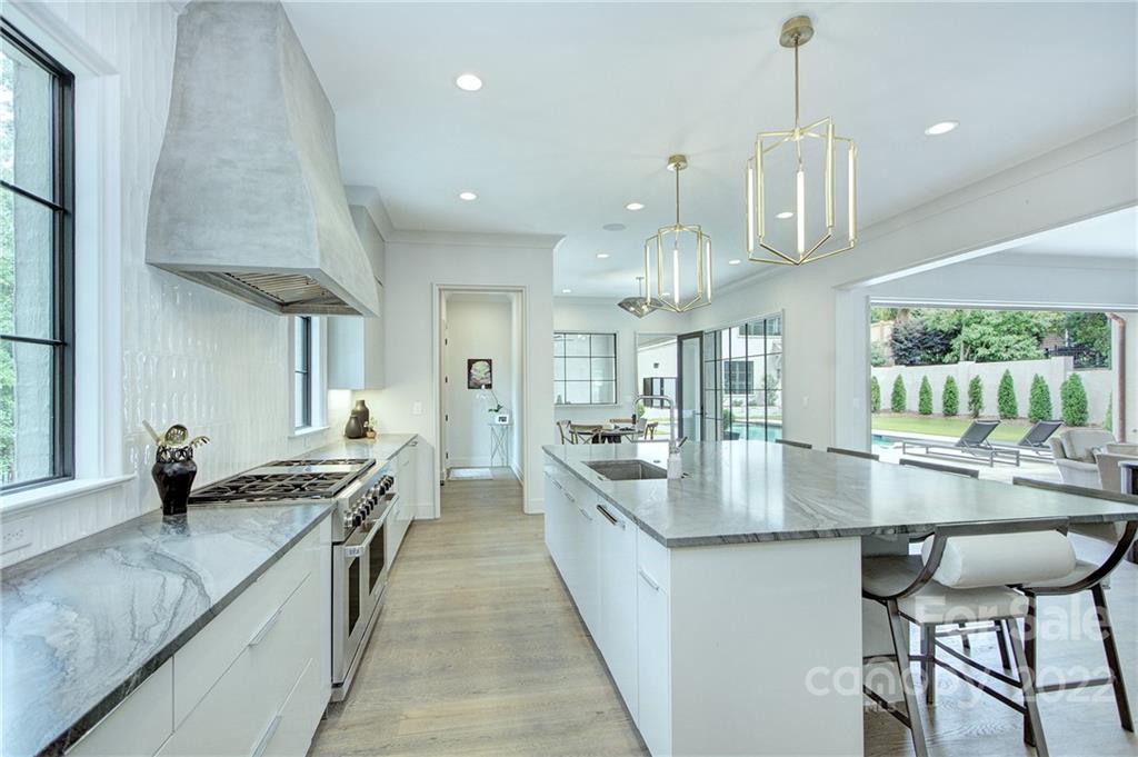 2027 Ferncliff Road Charlotte, NC 28211 - Photo 19 of 46 a kitchen with stainless steel appliances granite countertop a stove a sink and a refrigerator