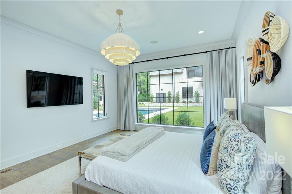 2027 Ferncliff Road Charlotte, NC 28211 - Photo 30 of 46 a bedroom with a large bed and a flat tv screen