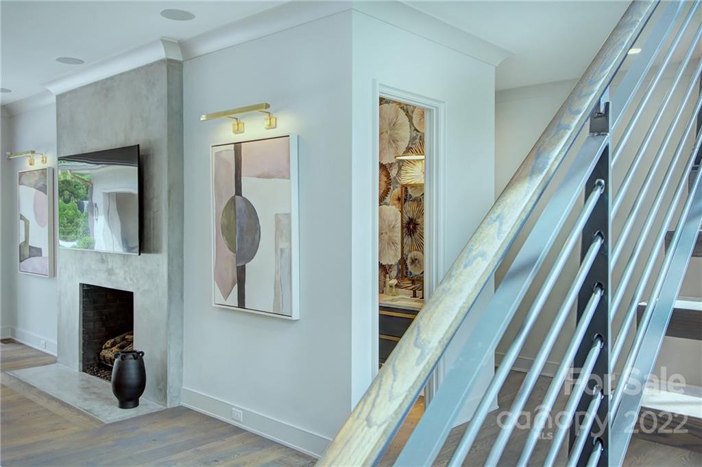 2027 Ferncliff Road Charlotte, NC 28211 - Photo 35 of 46 a view of a hallway with wooden floor and a fireplace