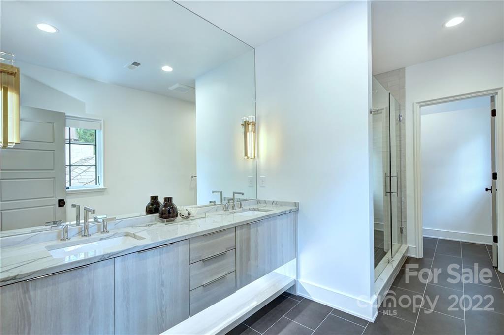 2027 Ferncliff Road Charlotte, NC 28211 - Photo 41 of 46 a bathroom with a double vanity sink and a mirror