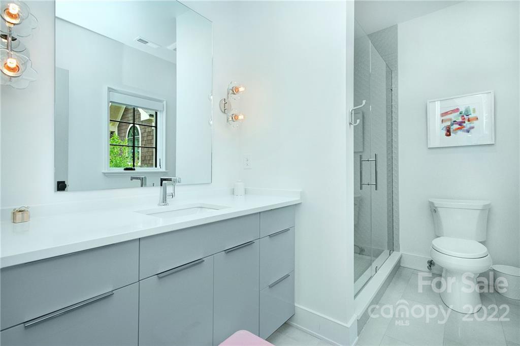 2027 Ferncliff Road Charlotte, NC 28211 - Photo 44 of 46 a bathroom with a toilet sink and mirror