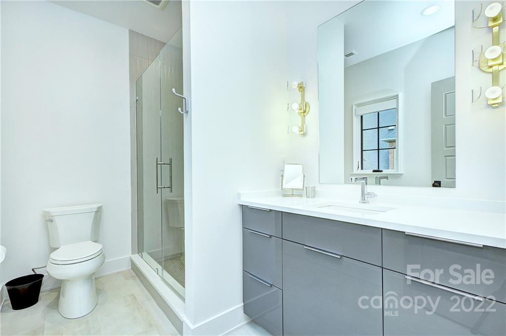 2027 Ferncliff Road Charlotte, NC 28211 - Photo 45 of 46 a bathroom with a toilet sink and mirror