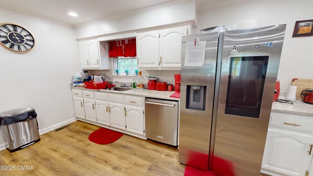 a living room with dining room and wooden floor