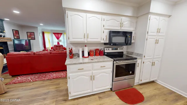 a living room with kitchen island furniture and a wooden floor