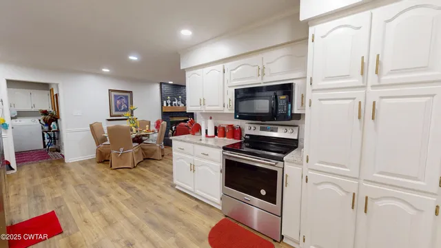 a living room with furniture a chandelier and a flat screen tv