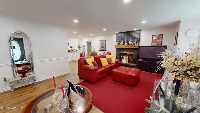 a living room with furniture fireplace and flat screen tv