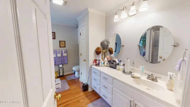 a bedroom with bed and wooden floor