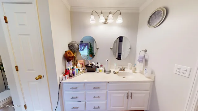 a bedroom with a bed and a television