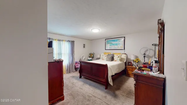 a bedroom with furniture and a wooden floor
