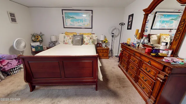 a bed sitting in a bedroom next to a lamp