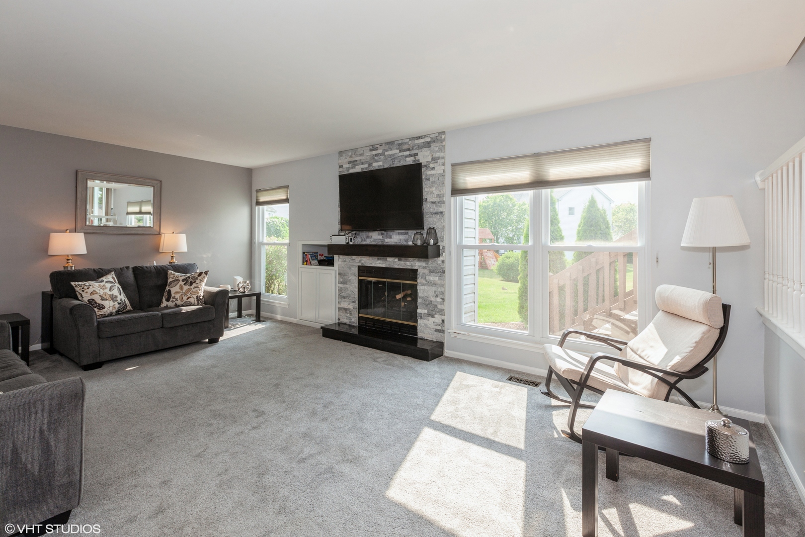 724 Wildflower Circle Naperville, IL 60540 - Photo 12 of 31 a living room with furniture a flat screen tv and a fireplace