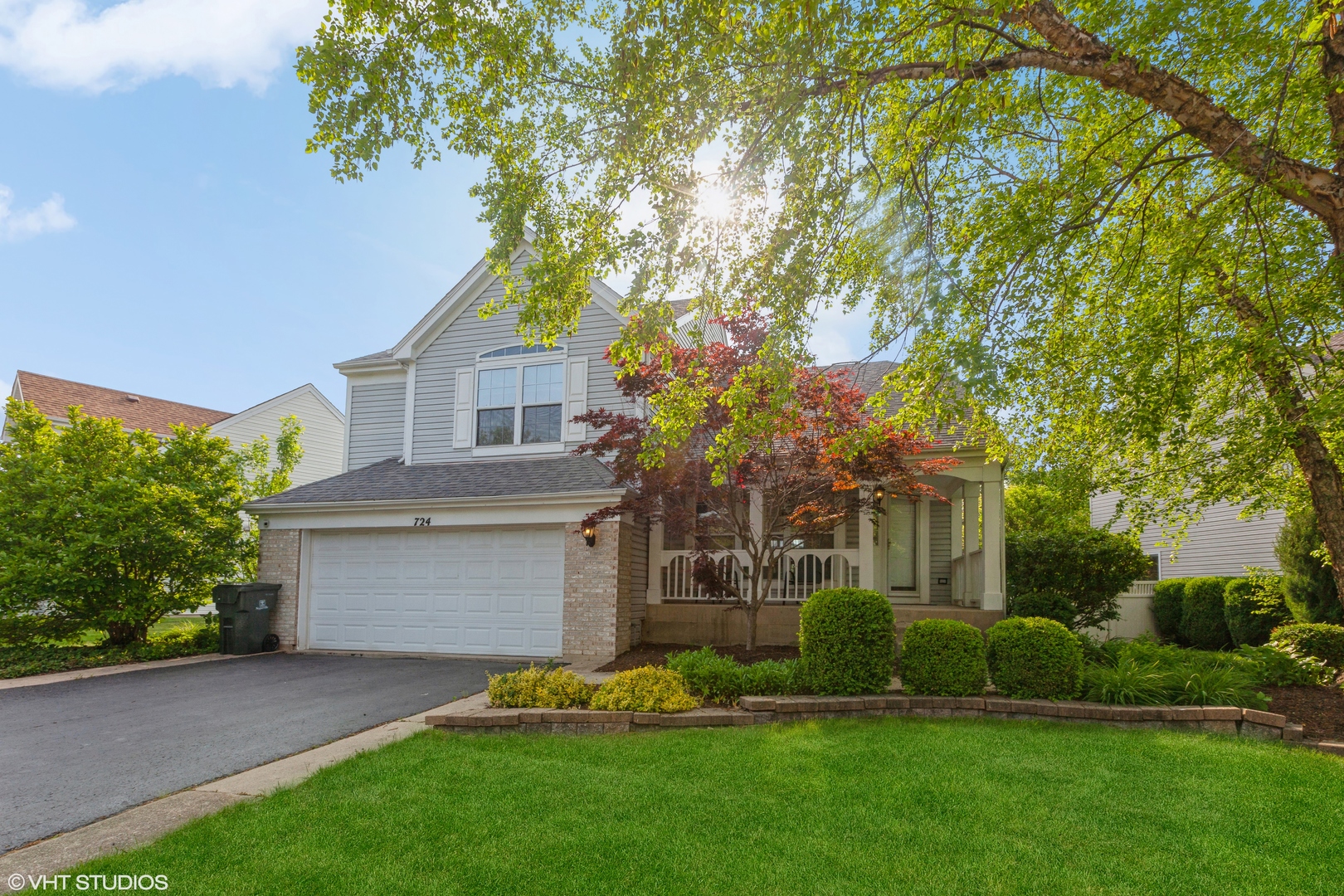 724 Wildflower Circle Naperville, IL 60540 - Photo 2 of 31 a front view of a house with a garden and tree