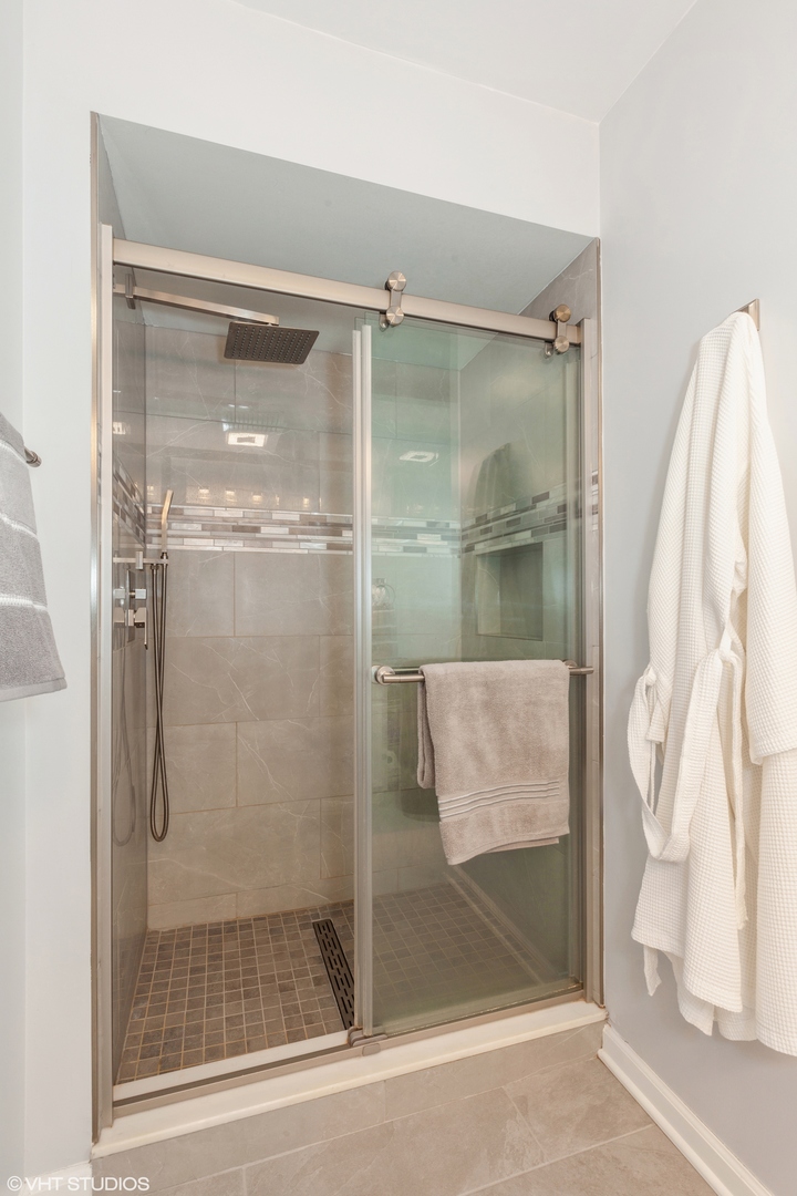 724 Wildflower Circle Naperville, IL 60540 - Photo 23 of 31 a bathroom with a glass shower door