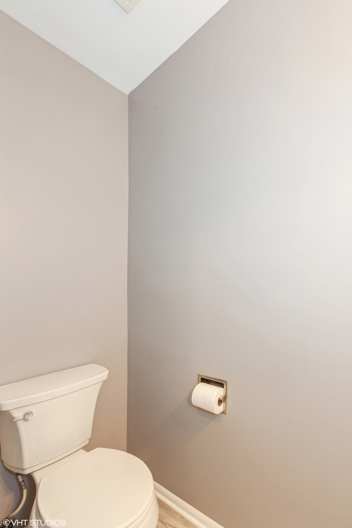 724 Wildflower Circle Naperville, IL 60540 - Photo 25 of 31 a white toilet sitting next to a white wall