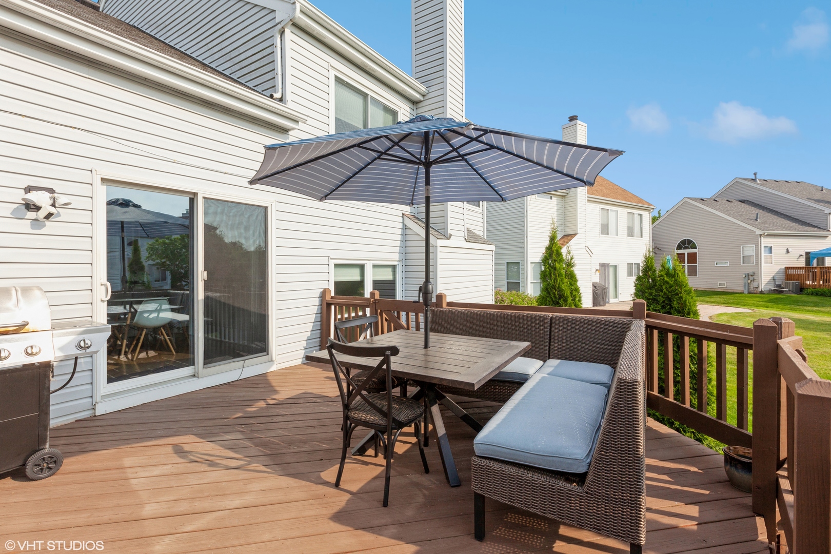 724 Wildflower Circle Naperville, IL 60540 - Photo 26 of 31 a view of a patio with table and chairs under an umbrella with wooden floor