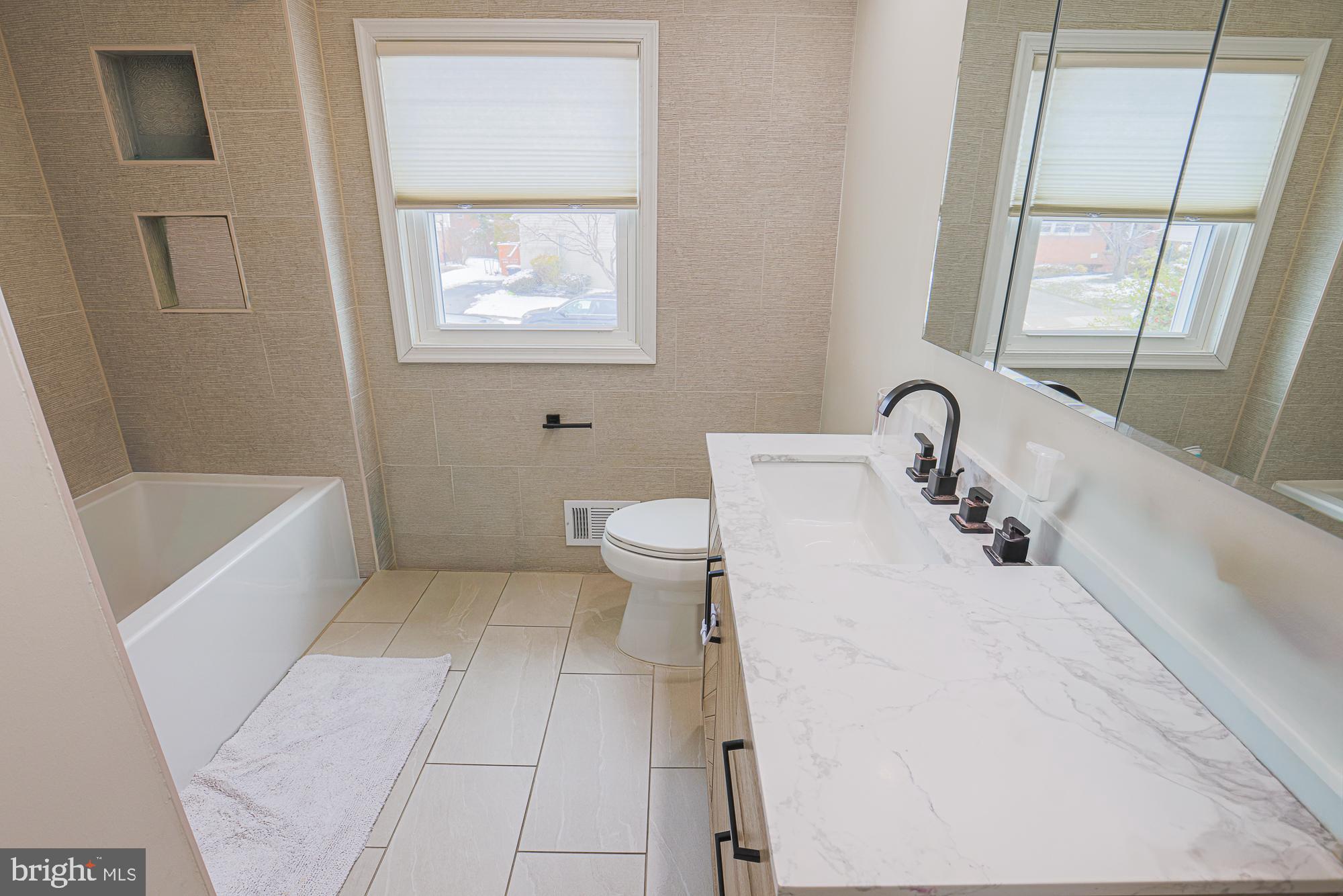 6600 Linco Avenue Baltimore, MD 21209 - Photo 18 of 24 a bathroom with a bathtub sink and toilet