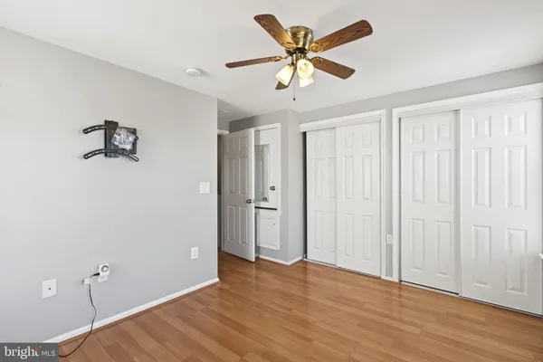 a bathroom with a granite countertop toilet and a sink