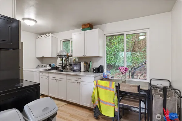 a kitchen with stainless steel appliances white cabinets and a refrigerator
