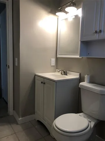 a white toilet sitting next to a bathroom sink